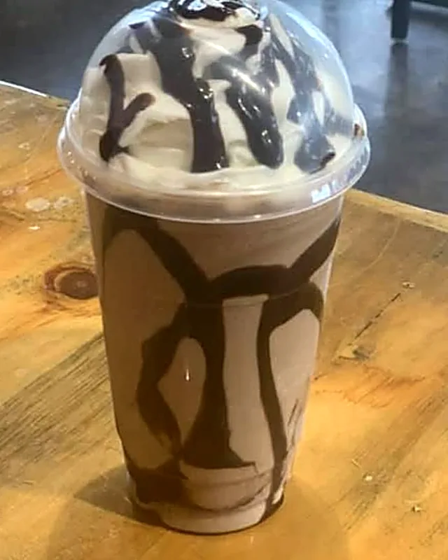A chocolate mocha freeze with whipped cream and chocolate drizzle